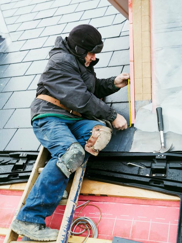 a-man-at-the-top-of-a-ladder-on-a-house-roof-fixing-tiles-on-a-dormer-roof-1-1.jpg a-man-at-the-top-of-a-ladder-on-a-house-roof-fixing-tiles-on-a-dormer-roof-1-1.jpg